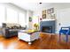 Cozy living room featuring hardwood floors, a stylish fireplace, and comfortable seating for relaxation and entertaining at 1036 23Rd N Ave, St Petersburg, FL 33704