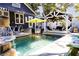 Backyard pool featuring a stone waterfall, surrounded by seating areas and lush landscaping for relaxation at 1036 23Rd N Ave, St Petersburg, FL 33704