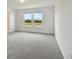 Bright bedroom features carpet flooring and a view of the outside at 10422 Cross River Trl, Parrish, FL 34219
