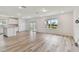 Bright living room features wood flooring and sliding glass doors to outdoor space at 10422 Cross River Trl, Parrish, FL 34219