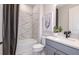 Modern bathroom with marble-style tile shower and sleek vanity at 10537 Longmeadow Ave, Parrish, FL 34219