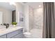 Bright bathroom features a shower over tub and a modern vanity at 10537 Longmeadow Ave, Parrish, FL 34219