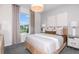 Comfortable bedroom features large window, neutral tones, and stylish decor at 10537 Longmeadow Ave, Parrish, FL 34219