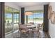 Bright dining area with sliding glass doors leading to a screened-in patio and views of the water at 10537 Longmeadow Ave, Parrish, FL 34219