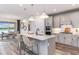 Elegant kitchen featuring an island with bar seating, stainless steel appliances, and granite countertops at 10537 Longmeadow Ave, Parrish, FL 34219