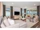 Bright living room with hardwood floors, modern furniture, and large windows for plenty of natural light at 10537 Longmeadow Ave, Parrish, FL 34219