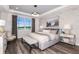 Comfortable primary bedroom featuring an elegant tray ceiling and a large window with beautiful views at 10537 Longmeadow Ave, Parrish, FL 34219