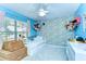 Charming ' bedroom featuring blue walls, plush toys, and ample natural light at 10928 Brickside Ct, Riverview, FL 33579