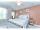 Cozy bedroom with a decorative accent wall, a ceiling fan, and lots of natural light at 10928 Brickside Ct, Riverview, FL 33579