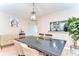 Bright dining room featuring stylish lighting, neutral walls, and a view to the kitchen at 10928 Brickside Ct, Riverview, FL 33579