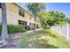 A view of the yard, community landscaping, and the back of the building at 10928 Brickside Ct, Riverview, FL 33579