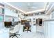 Comfortable, carpeted, fully-appointed home office with built-in shelving and cabinets, and lots of workspace at 10928 Brickside Ct, Riverview, FL 33579