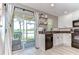 Kitchen with granite countertops, access to a screened patio, and modern appliances at 10928 Brickside Ct, Riverview, FL 33579