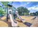 Attractive outdoor playground with a play structure with dual slides, swing set, and benches on a sunny day at 10928 Brickside Ct, Riverview, FL 33579