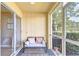 Cozy screened porch with comfortable seating, perfect for relaxation and enjoying the outdoors at 10928 Brickside Ct, Riverview, FL 33579