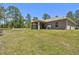 Spacious backyard with a covered patio, offering a perfect spot for outdoor activities at 11165 Little Gull Rd, Weeki Wachee, FL 34614
