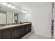 Bright bathroom featuring a double vanity, a large mirror, and decorative shower curtain at 11165 Little Gull Rd, Weeki Wachee, FL 34614