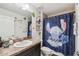 Fun bathroom with a sink vanity, a toilet and a blue shower curtain featuring an animated character at 11165 Little Gull Rd, Weeki Wachee, FL 34614