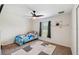 Cozy bedroom with ceiling fan, a window and a colorful rug, perfect for relaxation at 11165 Little Gull Rd, Weeki Wachee, FL 34614