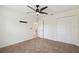 Bedroom featuring plush carpeting, a ceiling fan, and ample closet space at 11165 Little Gull Rd, Weeki Wachee, FL 34614