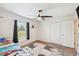 Comfortable bedroom with ceiling fan, a window with shades and a double door closet at 11165 Little Gull Rd, Weeki Wachee, FL 34614