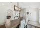 Spacious dining room with modern lighting open to kitchen and other living areas at 11165 Little Gull Rd, Weeki Wachee, FL 34614