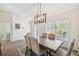 Light-filled dining area with modern lighting and ample natural light from window at 11165 Little Gull Rd, Weeki Wachee, FL 34614