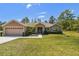 Charming single-story home with lush green lawn, two car garage and a welcoming front entrance at 11165 Little Gull Rd, Weeki Wachee, FL 34614