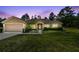 Inviting home with mature landscaping, well-manicured lawn, and attached two-car garage at 11165 Little Gull Rd, Weeki Wachee, FL 34614