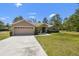 Inviting home with a wide driveway, a two-car garage, and well-maintained landscaping with green grass at 11165 Little Gull Rd, Weeki Wachee, FL 34614