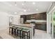 Island kitchen with seating area for four next to stainless steel appliances at 11165 Little Gull Rd, Weeki Wachee, FL 34614