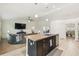Island kitchen area with stainless steel sink and dishwasher next to an airy living room at 11165 Little Gull Rd, Weeki Wachee, FL 34614