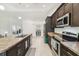 A kitchen featuring stainless steel appliances, an island and dark wood cabinets at 11165 Little Gull Rd, Weeki Wachee, FL 34614