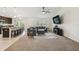 Open-concept layout with kitchen island and stainless steel appliances flowing into a living room at 11165 Little Gull Rd, Weeki Wachee, FL 34614