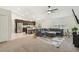 Open-concept living room with ceiling fan adjacent to modern kitchen at 11165 Little Gull Rd, Weeki Wachee, FL 34614