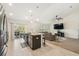 A living room with a fan, sectional couch, lights, carpet, and an entertainment center at 11165 Little Gull Rd, Weeki Wachee, FL 34614
