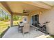 Covered patio with outdoor seating, ceiling fan, and access to the backyard at 11165 Little Gull Rd, Weeki Wachee, FL 34614