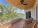 Relaxing covered balcony featuring outdoor seating with views of lush surrounding greenery at 12033 Gandy N Blvd # 131, St Petersburg, FL 33702