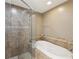 A spacious bathroom with a glass shower, a soaking tub, and neutral tones at 12033 Gandy N Blvd # 131, St Petersburg, FL 33702