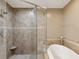 A spacious bathroom with a glass shower, a soaking tub, and neutral tones at 12033 Gandy N Blvd # 131, St Petersburg, FL 33702