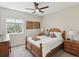 Cozy bedroom featuring natural light, a ceiling fan, and stylish decor over the wooden bed frame at 12033 Gandy N Blvd # 131, St Petersburg, FL 33702