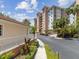 Beautiful condo building exterior with well-maintained landscaping and a paved driveway at 12033 Gandy N Blvd # 131, St Petersburg, FL 33702