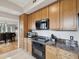 Kitchen features stainless steel appliances, granite counters, and wood cabinetry at 12033 Gandy N Blvd # 131, St Petersburg, FL 33702