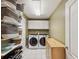 Organized laundry room featuring a washer, dryer, storage cabinets, and shelving with baskets at 12033 Gandy N Blvd # 131, St Petersburg, FL 33702