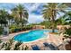 Inviting community pool area surrounded by lush landscaping and comfortable lounge chairs at 12033 Gandy N Blvd # 131, St Petersburg, FL 33702