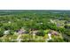 Aerial view showing a neighborhood with mature trees, lush landscaping, and well-maintained properties at 12503 Bronco Dr, Tampa, FL 33626