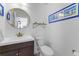 Stylish bathroom with a round mirror, framed print and a modern vanity at 12503 Bronco Dr, Tampa, FL 33626