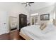 Spacious bedroom with hardwood floors, desk, and french doors to the backyard pool at 12503 Bronco Dr, Tampa, FL 33626