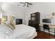 Bedroom featuring hardwood floors, a desk and a view into the ensuite bath at 12503 Bronco Dr, Tampa, FL 33626
