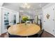 Bright dining area with a wood table, black chairs, and view to the kitchen and backyard at 12503 Bronco Dr, Tampa, FL 33626